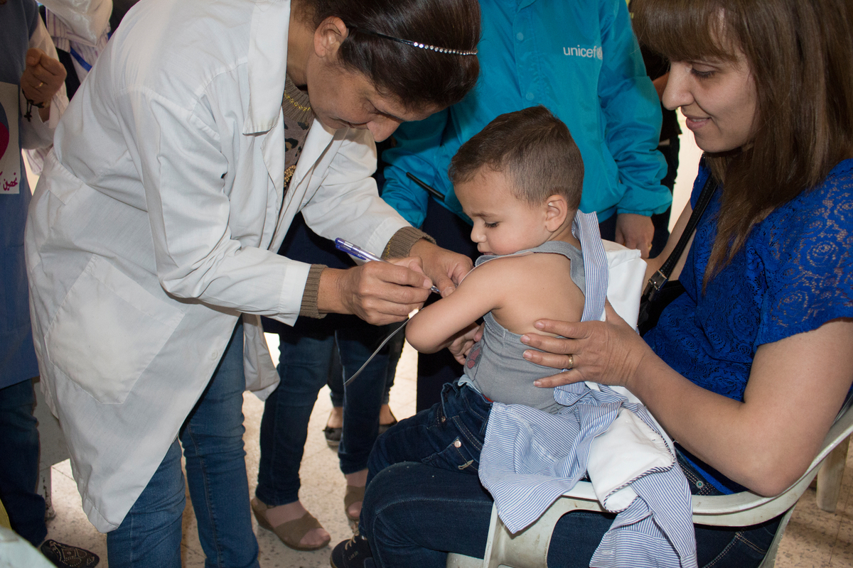 On 23 May 2017 in the Syrian Arab Republic, after receiving measles vaccination, four-year old George is being screened for malnutrition at a health centre in Ghassaniya in rural Homs.

UNICEF and WHO supported the Ministry of Health to undertake a nationwide immunization campaign inside Syria this week. The campaign aims to reach 2 million children between the ages of seven months and five years in 12 governorates  in Syria.  UNICEF provided 3 million doses of measles vaccine, 3 million syringes and safety boxes, and supported social mobilization, and awareness raising initiatives through distributing mass communication material.  Over 8,000 vaccinators have been deployed in health centres and through mobile teams providing vaccinations during the five-day campaign, including in temporary shelters housing displaced families like Mabrouka, north-eastern Syria.  Before the current crisis, SyriaÕs immunization coverage was one of the best in the region. Immunization coverage dropped from 80 per cent pre-conflict to 41 per cent in 2015. In some of the contested areas, routine immunization has completely stopped triggering diseases outbreaks including measles.