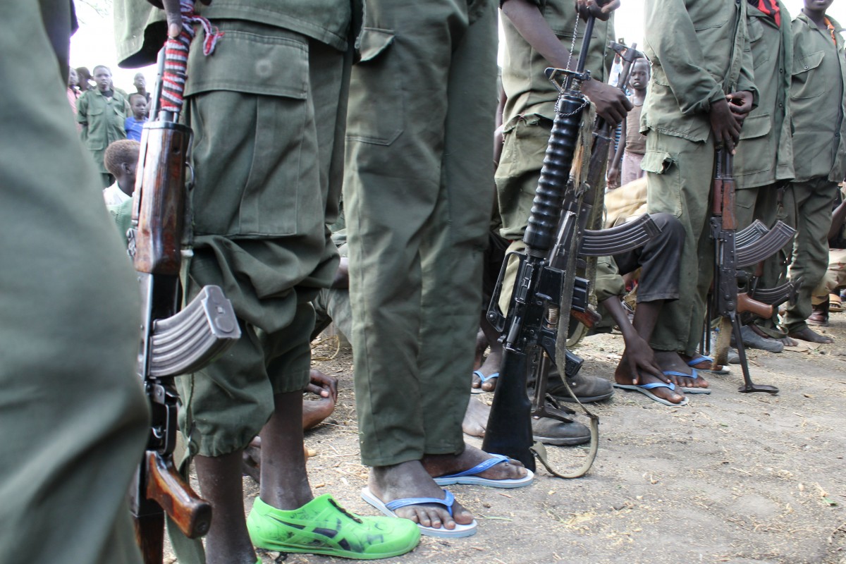 On 21 March, children queue to hand over their weapons and uniforms during a ceremony formalizing their release from the South Sudan Democratic Army (SSDA) Cobra Faction armed group, in the remote village of Lekuangole, in Jonglei State.

On 21 March 2015 in South Sudan, up to 250 children  including four girls, one as young as 9  were released today from the South Sudan Democratic Army (SSDA) Cobra Faction armed group. Another 400 are being released over the next two days. The release happened in the remote village of Lekuangole, in Jonglei State. It is the third release of children following a peace deal between the Faction and the Government. The Governments National Disarmament, Demobilization and Reintegration Commission (NDDRC) and UNICEF are working together to care for the children and reintegrate them in their communities. The Cobra Faction has advised UNICEF that they have up to 3,000 children in their armed group. In a ceremony led by the NDDRC formalizing the childrens release, the children exchanged their weapons and uniforms for civilian clothing. UNICEF then took responsibility for looking after the children at an interim care centre in the village, where they are being provided with food, shelter and medical care. UNICEF and partners will begin the process of tracing their families and, where necessary, providing psychosocial support.